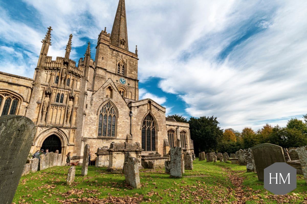 Wide shot of church and churchyard with headstones